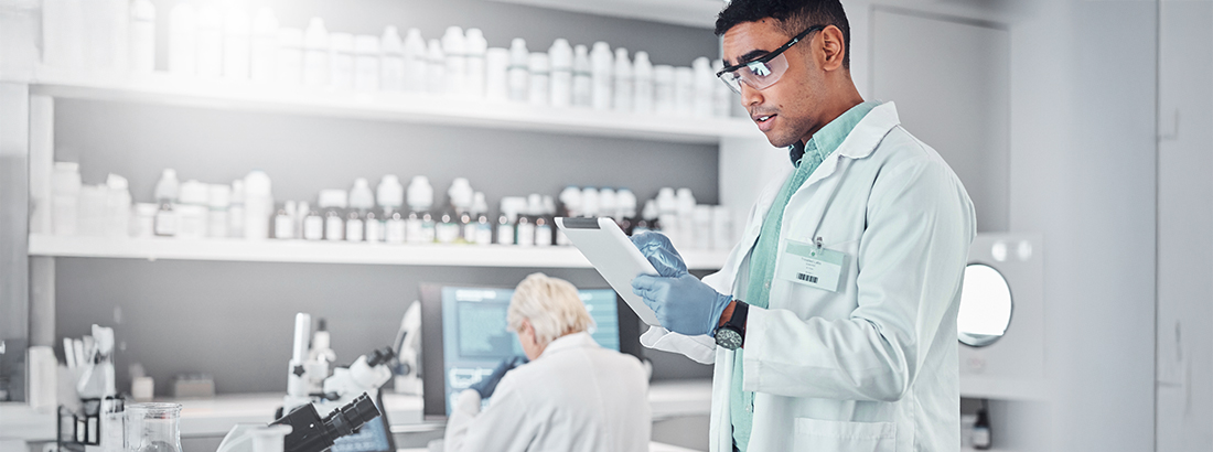 Scientist reviewing data on a tablet in a laboratory
